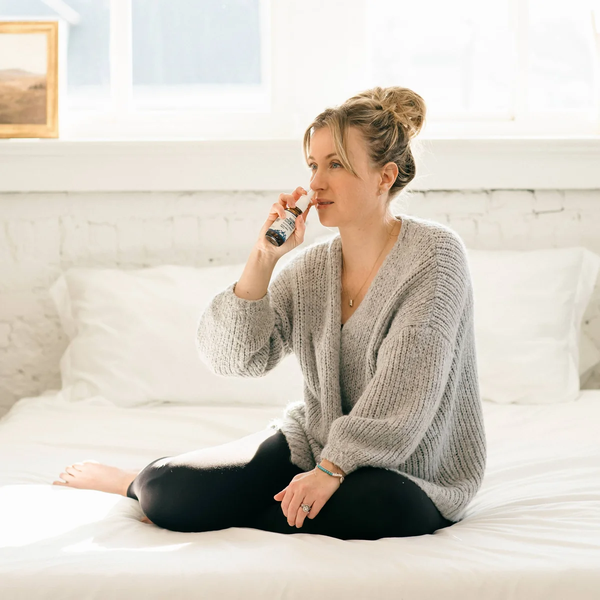 Woman using Nasomin nasal spray
